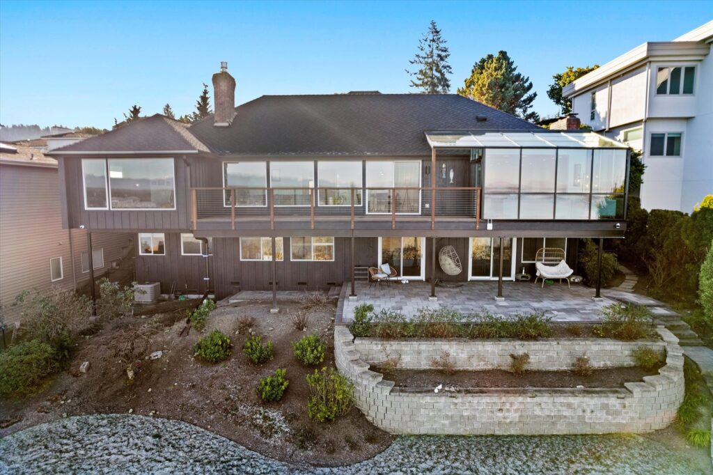 Freshly repainted two-story home exterior with dark body color and white trim in the Pacific Northwest